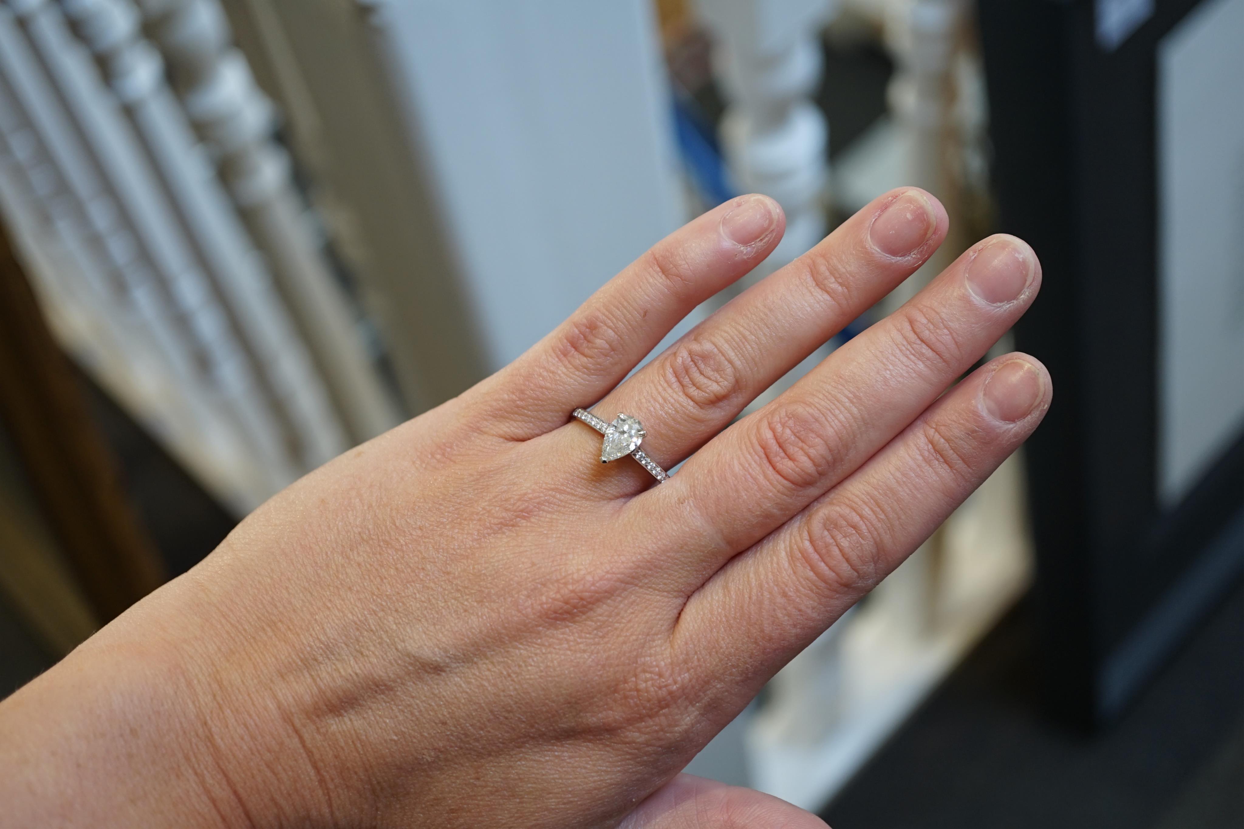A recent Boodles platinum and single stone pear cut diamond set Harmony design ring, with diamond chip set shoulders and setting